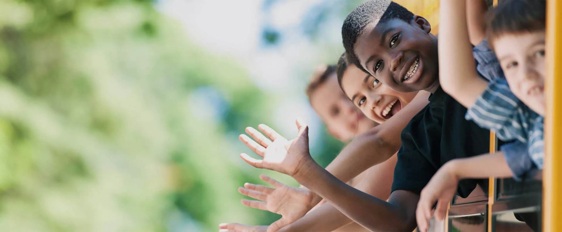 Kids waving and smiling