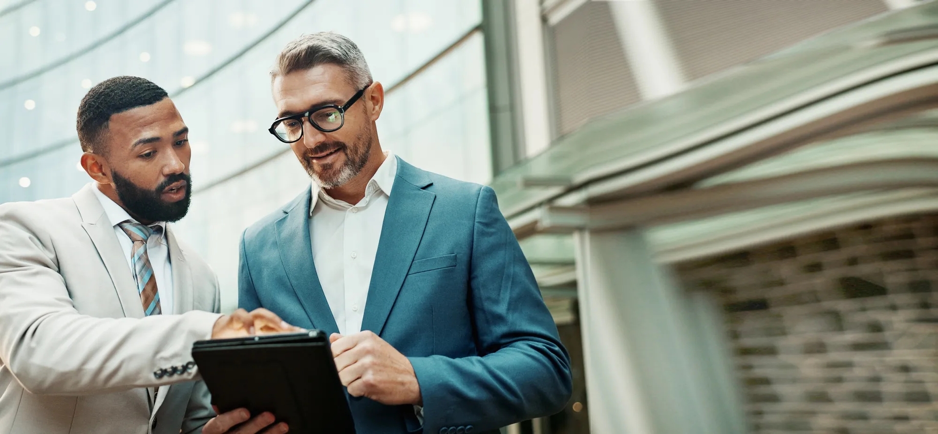 Two men looking at a tablet Two men looking at a tablet